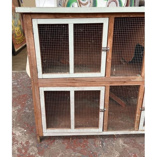 47 - A wooden two tier rabbit hutch - approx. 113cm high x 152cm wide x 61cm deep