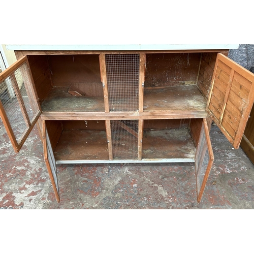 47 - A wooden two tier rabbit hutch - approx. 113cm high x 152cm wide x 61cm deep