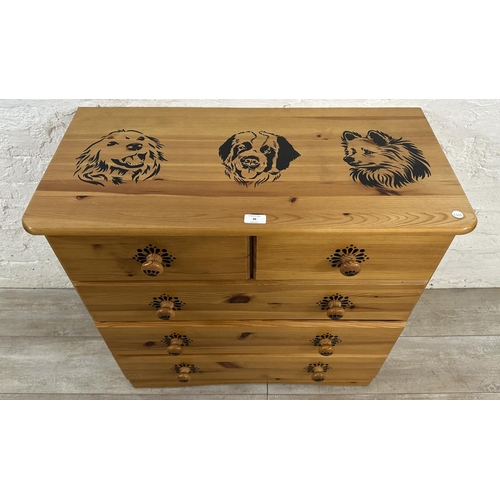 48 - A pine chest of drawers with dog design - approx. 74cm high x 80cm wide x 39cm deep