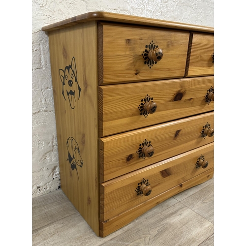 48 - A pine chest of drawers with dog design - approx. 74cm high x 80cm wide x 39cm deep