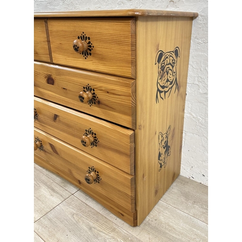 48 - A pine chest of drawers with dog design - approx. 74cm high x 80cm wide x 39cm deep