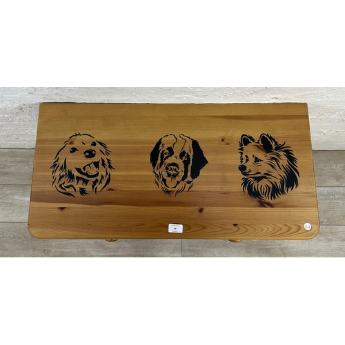 48 - A pine chest of drawers with dog design - approx. 74cm high x 80cm wide x 39cm deep