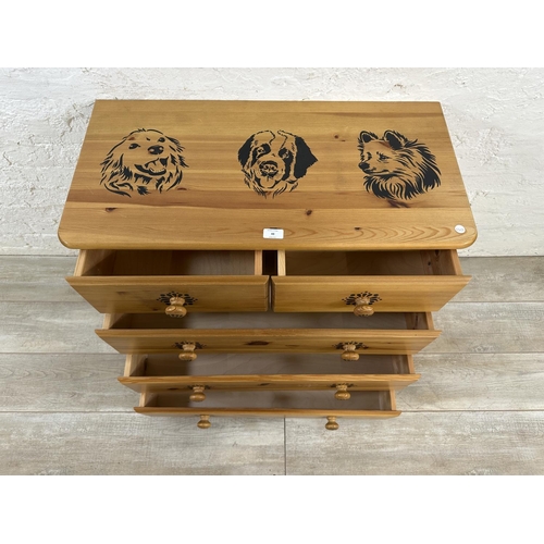 48 - A pine chest of drawers with dog design - approx. 74cm high x 80cm wide x 39cm deep