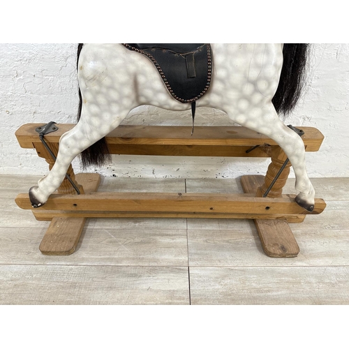 5 - A Victorian style hand painted carved hardwood rocking horse on pine stand - approx. 108cm high x 54... 