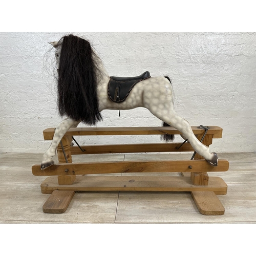 5 - A Victorian style hand painted carved hardwood rocking horse on pine stand - approx. 108cm high x 54... 