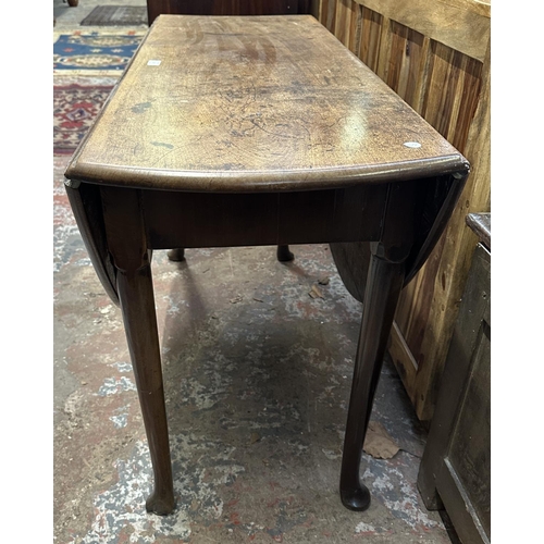 52 - A George II mahogany drop leaf gate leg pad foot table - approx. 70cm high x 123cm wide x 130cm long