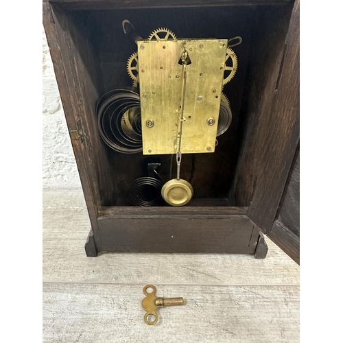 53 - An early 20th century British New Haven oak cased chiming mantel clock with key and pendulum - appro... 