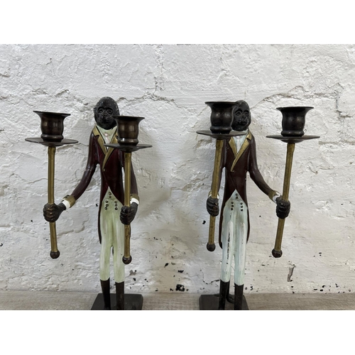 56 - A pair of Indian hand painted cast metal butler monkey twin branch candelabras - approx. 41cm high