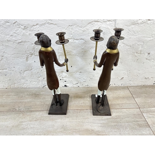 56 - A pair of Indian hand painted cast metal butler monkey twin branch candelabras - approx. 41cm high