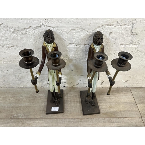 57 - A pair of Indian hand painted cast metal butler monkey twin branch candelabras - approx. 41cm high