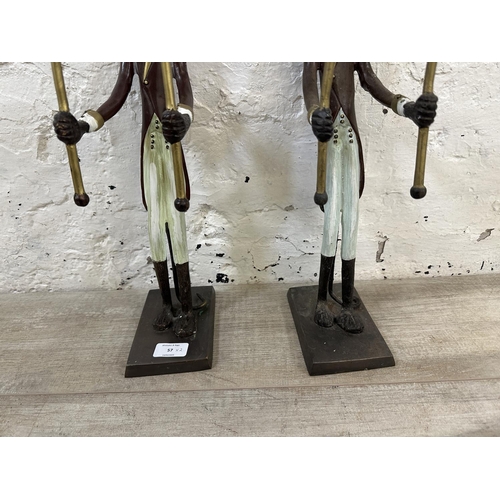 57 - A pair of Indian hand painted cast metal butler monkey twin branch candelabras - approx. 41cm high