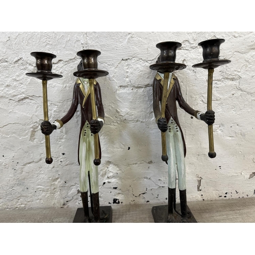 57 - A pair of Indian hand painted cast metal butler monkey twin branch candelabras - approx. 41cm high