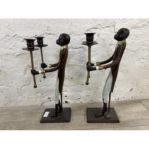 57 - A pair of Indian hand painted cast metal butler monkey twin branch candelabras - approx. 41cm high