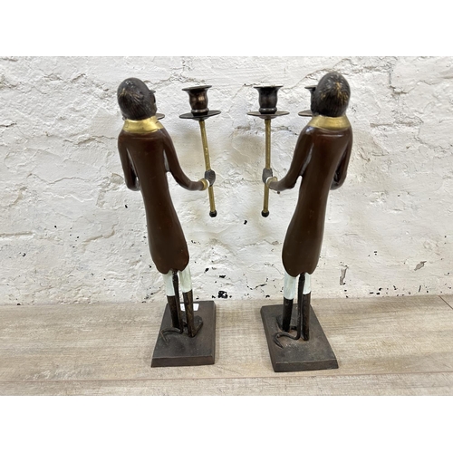 57 - A pair of Indian hand painted cast metal butler monkey twin branch candelabras - approx. 41cm high