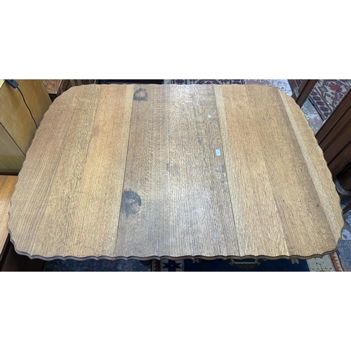 58 - An early 20th century oak pie crust edge drop leaf gate leg barley twist dining table