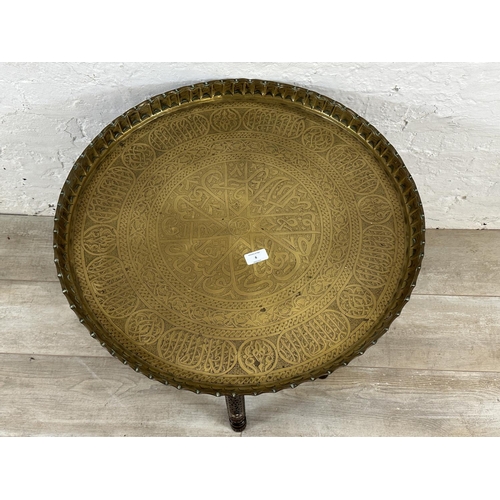 6 - A Middle Eastern inlaid carved hardwood folding travel table with engraved brass charger/tray - appr... 