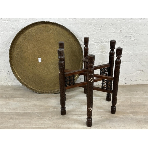 6 - A Middle Eastern inlaid carved hardwood folding travel table with engraved brass charger/tray - appr... 