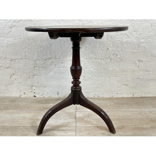 64 - A George III oak circular tilt top tripod side table - approx. 68cm high x 57cm diameter