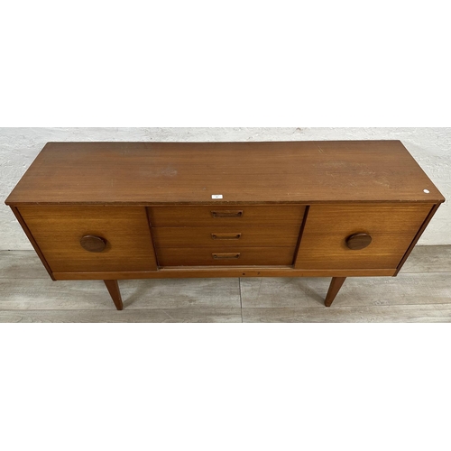 69 - A mid 20th century teak sideboard - approx. 72cm high x 154cm wide x 40cm deep