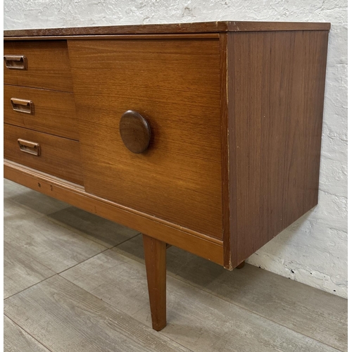 69 - A mid 20th century teak sideboard - approx. 72cm high x 154cm wide x 40cm deep