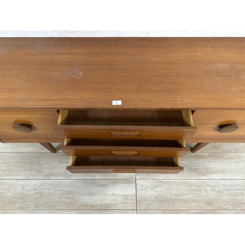 69 - A mid 20th century teak sideboard - approx. 72cm high x 154cm wide x 40cm deep