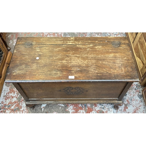 76 - A 1930s carved oak blanket box - approx. 57cm high x 91cm wide x 43cm deep