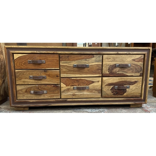 77 - An Indian sheesham wood chest of drawers - approx. 66cm high x 145cm wide x 45.5cm deep