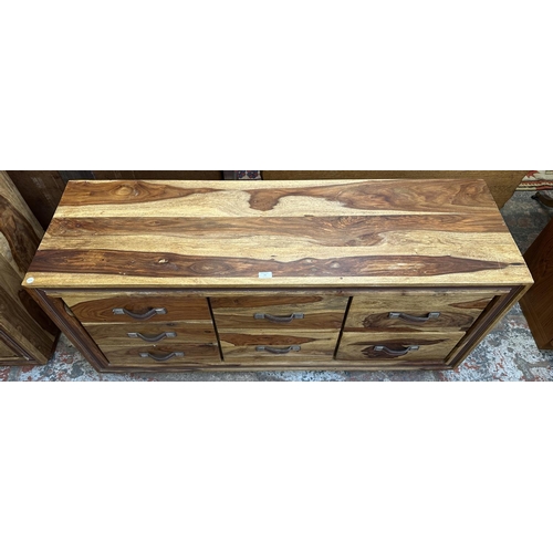 77 - An Indian sheesham wood chest of drawers - approx. 66cm high x 145cm wide x 45.5cm deep