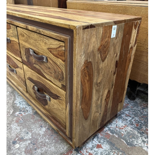 77 - An Indian sheesham wood chest of drawers - approx. 66cm high x 145cm wide x 45.5cm deep