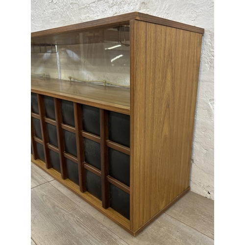 90 - A mid 20th century teak effect and black vinyl drinks cabinet - approx. 65cm high x 107cm wide x 36c... 