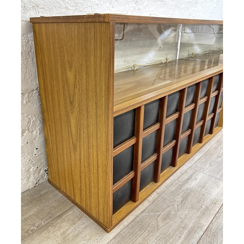 90 - A mid 20th century teak effect and black vinyl drinks cabinet - approx. 65cm high x 107cm wide x 36c... 