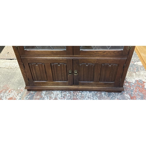 93 - A Priory style carved oak and lead glazed bookcase - approx. 137cm high x 96cm wide x 31cm deep