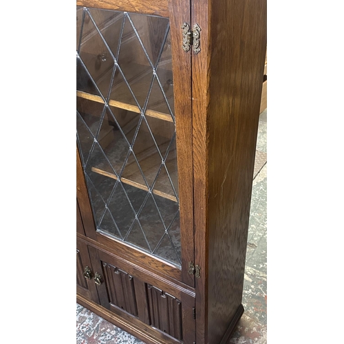 93 - A Priory style carved oak and lead glazed bookcase - approx. 137cm high x 96cm wide x 31cm deep