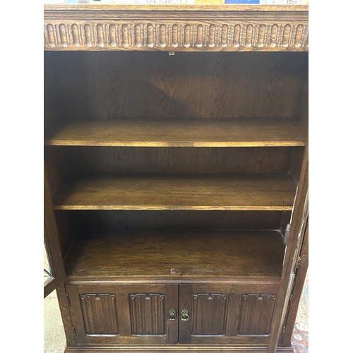 93 - A Priory style carved oak and lead glazed bookcase - approx. 137cm high x 96cm wide x 31cm deep