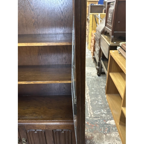 93 - A Priory style carved oak and lead glazed bookcase - approx. 137cm high x 96cm wide x 31cm deep