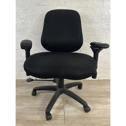 99 - A modern black plastic and fabric swivel office desk chair