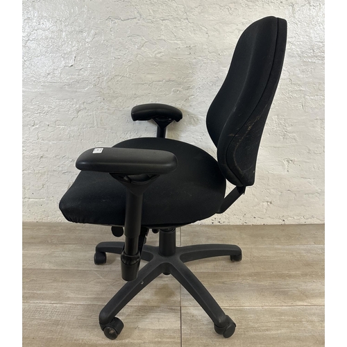 99 - A modern black plastic and fabric swivel office desk chair