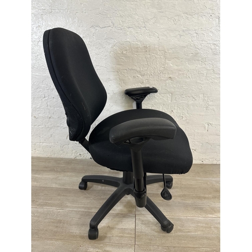 99 - A modern black plastic and fabric swivel office desk chair