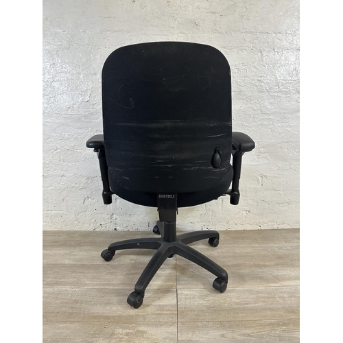 99 - A modern black plastic and fabric swivel office desk chair