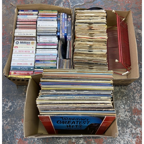 768 - Three boxes containing a 7 inch vinyl record display rack, approx. two hundred and thirty vinyl reco... 