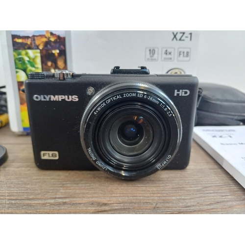 694 - A boxed and cased Olympus XZ-1 10mp CCD sensor compact digital camera with cables and instruction ma... 