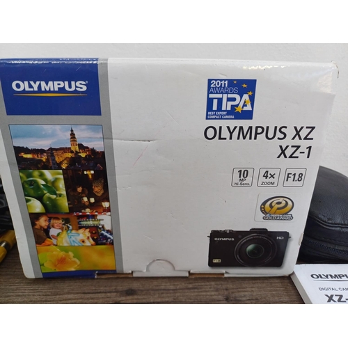 694 - A boxed and cased Olympus XZ-1 10mp CCD sensor compact digital camera with cables and instruction ma... 