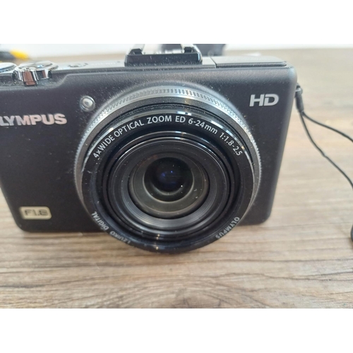 694 - A boxed and cased Olympus XZ-1 10mp CCD sensor compact digital camera with cables and instruction ma... 