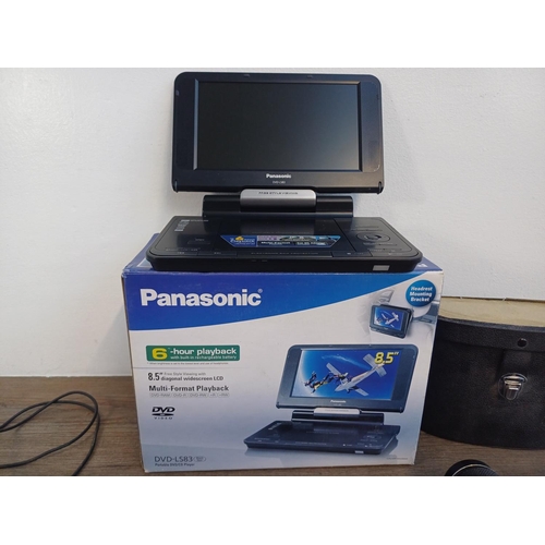 703 - Seven items, one boxed Panasonic DVD-LS83 portable DVD player with accessories and instruction manua... 