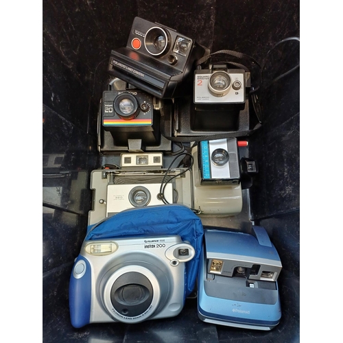 683 - A collection of instant cameras to include Fujifilm Instax 200, Polaroid ONE600 etc.