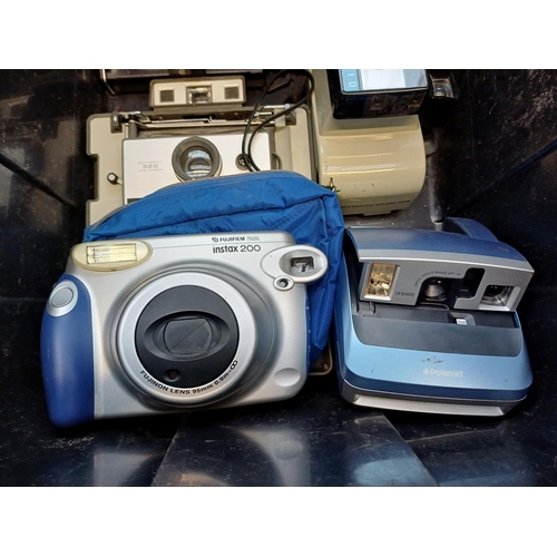 683 - A collection of instant cameras to include Fujifilm Instax 200, Polaroid ONE600 etc.