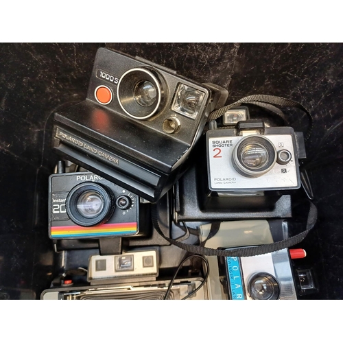 683 - A collection of instant cameras to include Fujifilm Instax 200, Polaroid ONE600 etc.