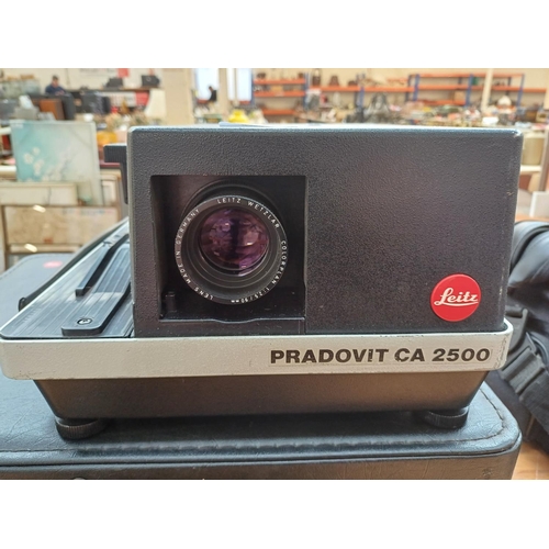 724 - A cased Leitz Pradovit CA2500 slide projector fitted with Colorplan 1:2.5/90mm lens