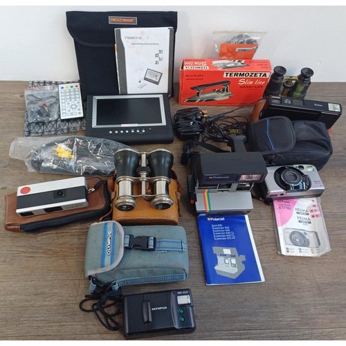 672 - A collection of items to include cased Olympus AM-100 compact 35mm camera, cased Polaroid Supercolor... 