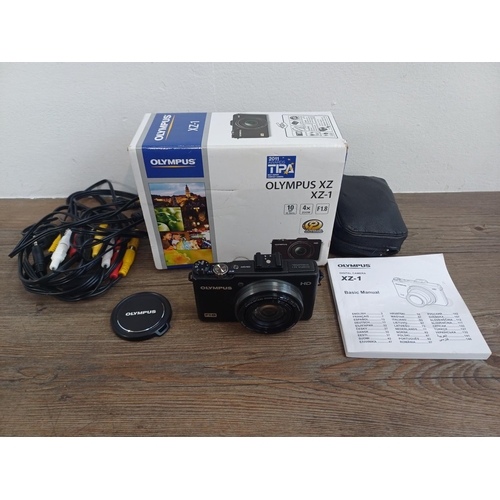 694 - A boxed and cased Olympus XZ-1 10mp CCD sensor compact digital camera with cables and instruction ma... 